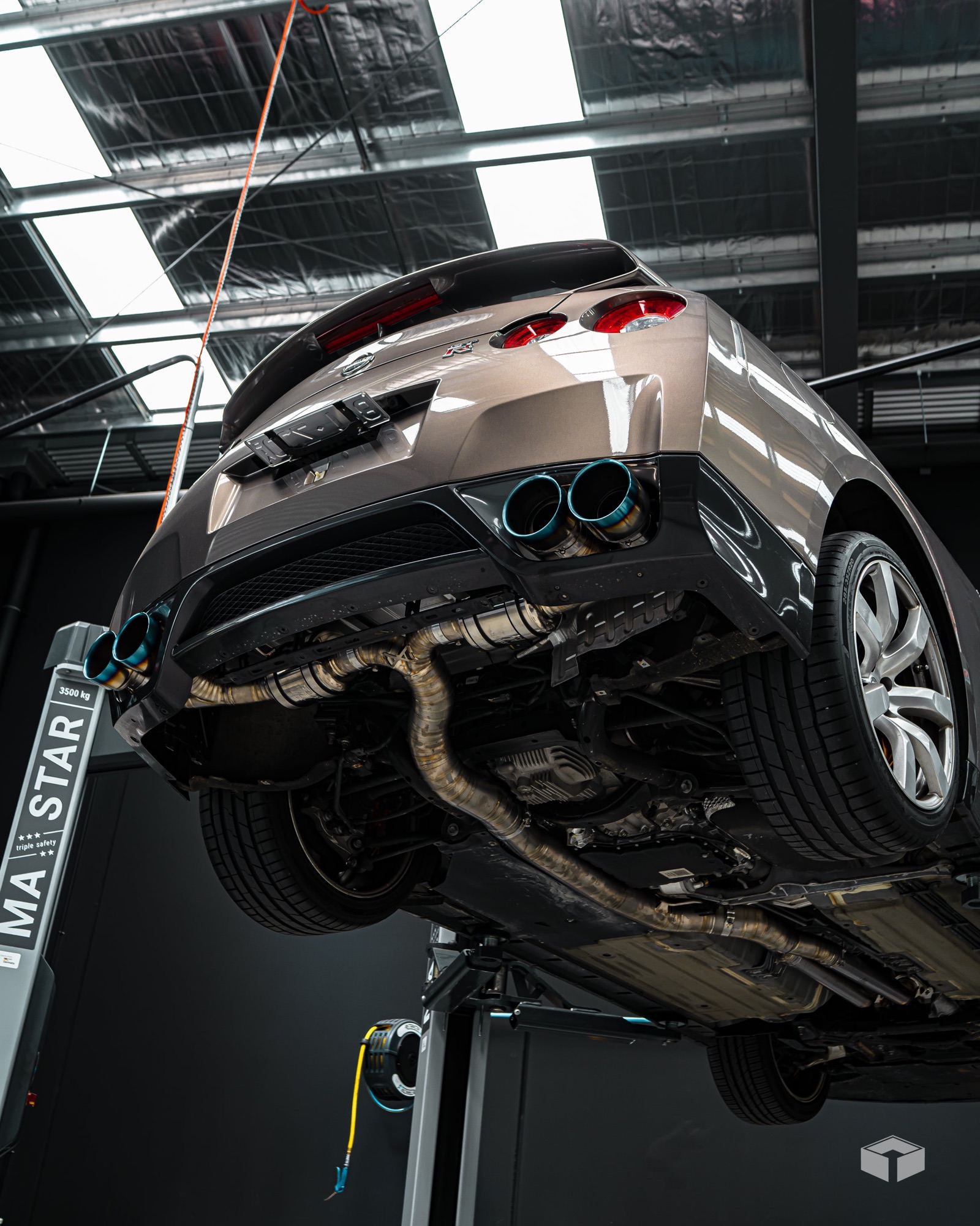 GT-R on the hoist with a titanium exhaust